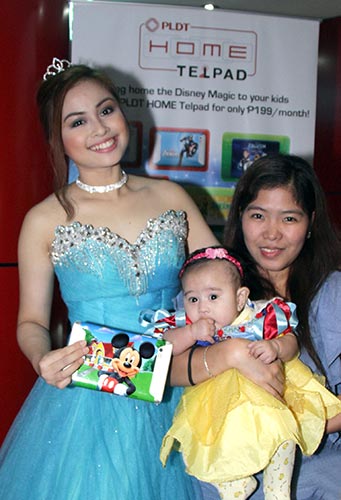 Baby dressed in her favorite princess costume with a Telpad in Mickey Mouse skin.