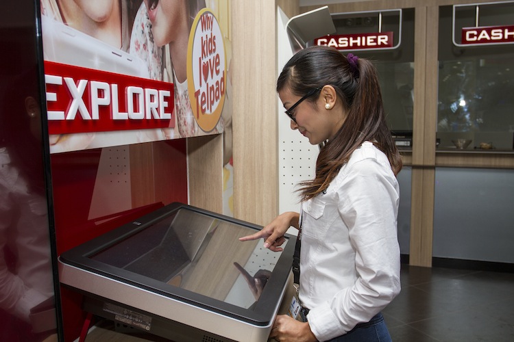 PLDT Customer Care Assistants try out the new digital screens in the store